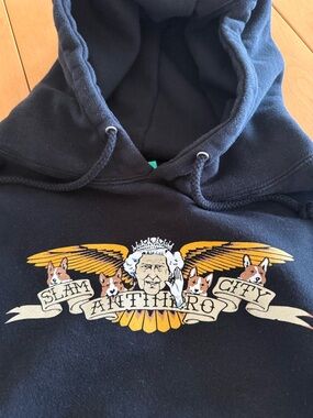 Black Graphic Pullover Hoodie with Yellow Crest Design